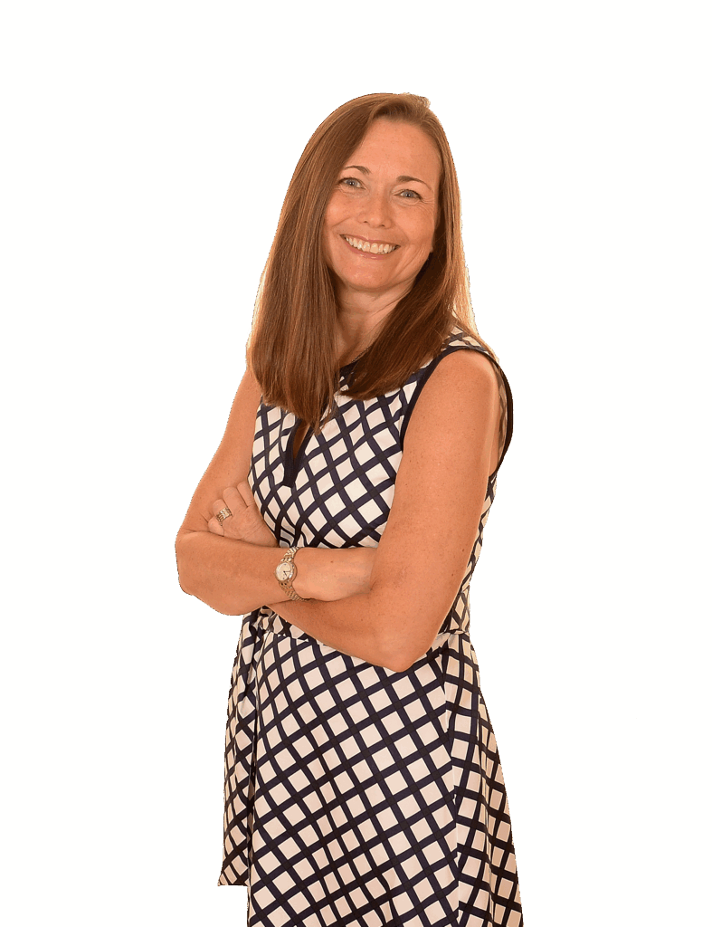 Woman with long brown hair stands smiling with arms crossed, wearing a sleeveless, black and white checkered dress against a plain white background.
