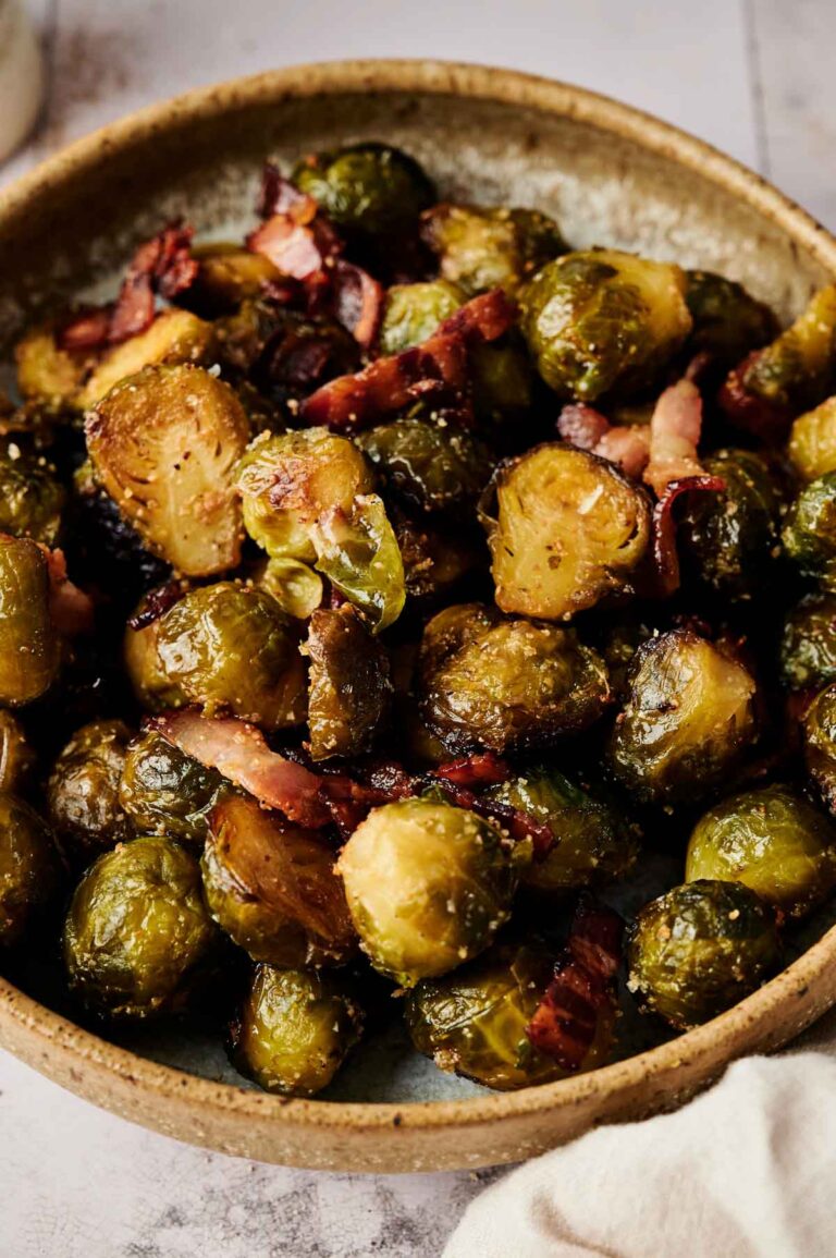 A bowl of Brussels Sprouts with Bacon features roasted Brussels sprouts perfectly mixed with crispy bacon pieces.