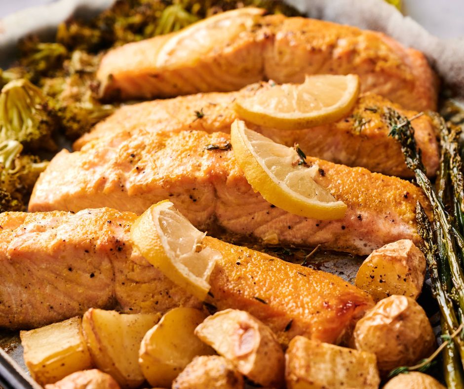 Sheet Pan Salmon fillets baked with lemon slices, roasted potatoes, and asparagus arranged on a baking sheet for an easy, flavorful meal.
