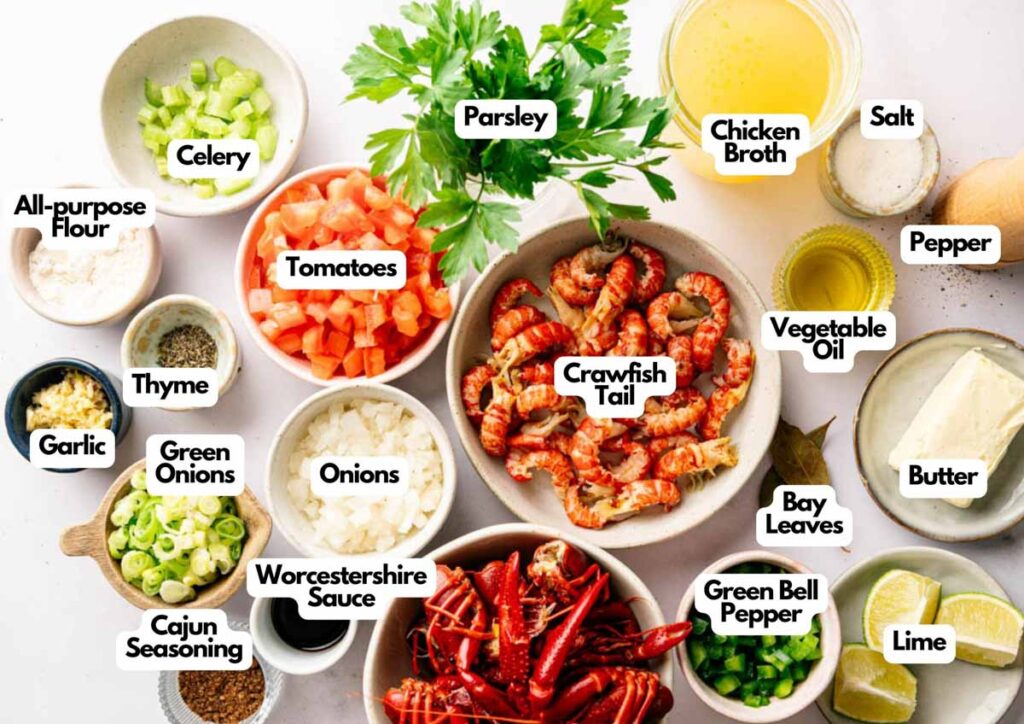 Various labeled ingredients for Crawfish Etouffee are arranged on a white surface, including crawfish tails, vegetables, seasonings, broth, and butter.