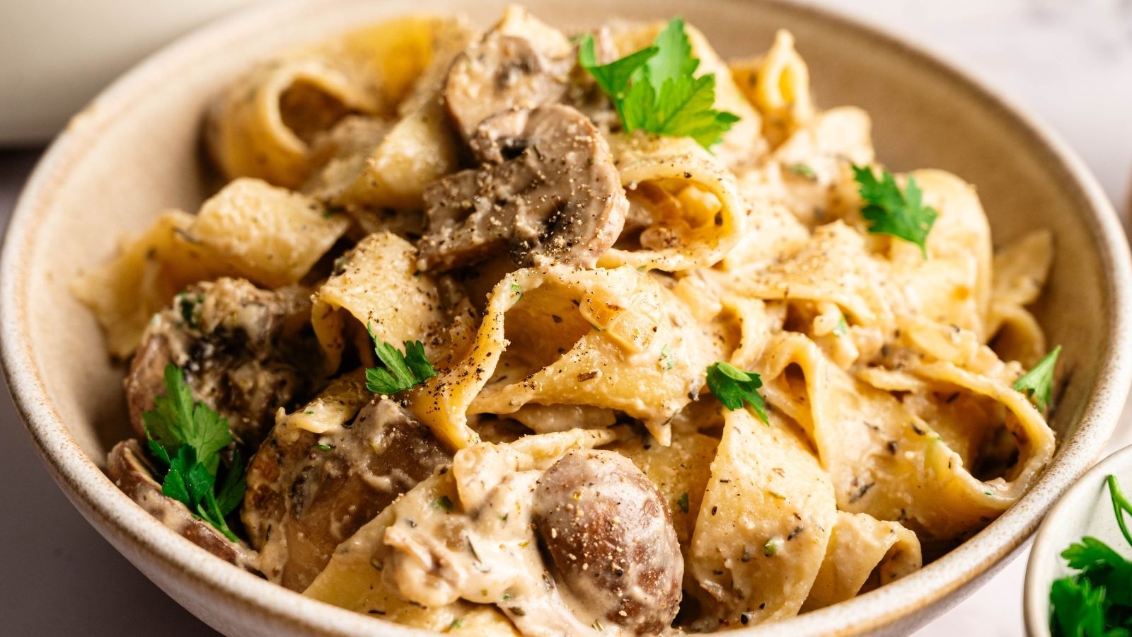 Cupcakes decorated with green frosting and chocolate footballs, arranged on a surface resembling a grass field.