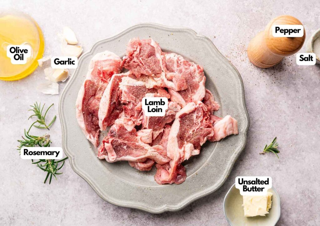 Raw Lamb Loin Chops on a plate, surrounded by labeled ingredients: olive oil, garlic, rosemary, unsalted butter, salt, and pepper.